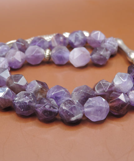 Close-up of polished amethyst beads showing deep purple color