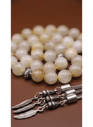 Detail of feather charm accents on citrine prayer beads