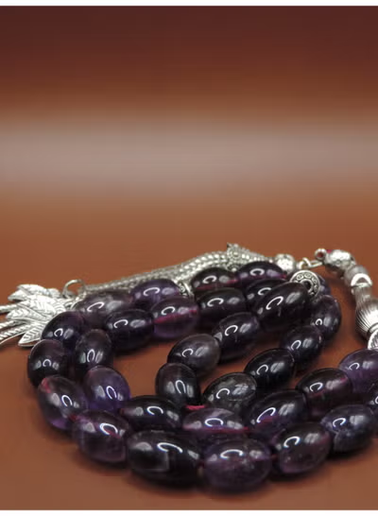 Polished amethyst oval beads showing natural variations