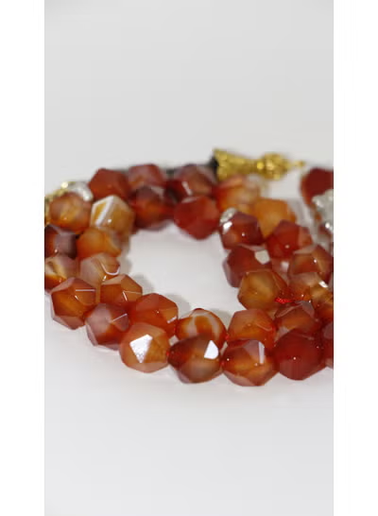 Close-up of polished red agate gemstone beads